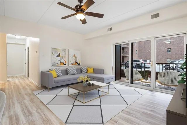 a view of a livingroom with wooden floor and window