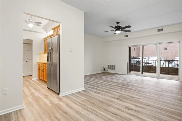 a view of empty room with wooden floor