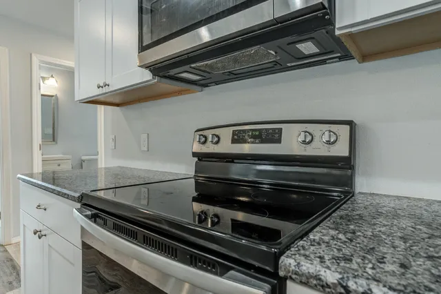 a stove top oven sitting inside of a kitchen
