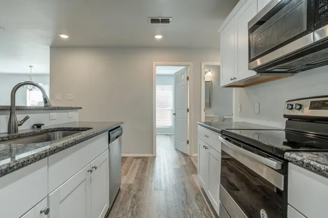 a kitchen with a sink stove and cabinets