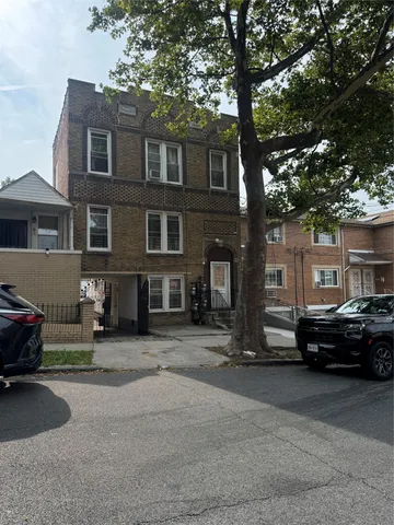 a car parked in front of a brick house