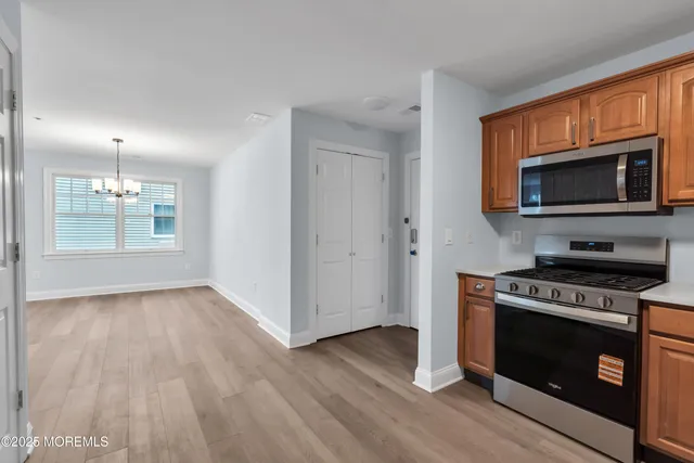 a kitchen with a stove a microwave and window