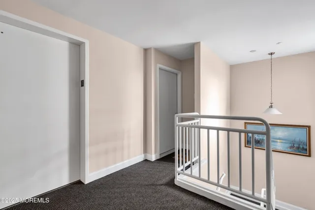 a view of a hallway with staircase