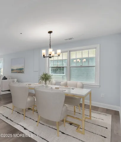 a view of a dining room with furniture and window