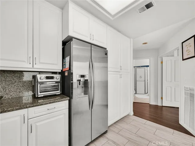 a kitchen with stainless steel appliances granite countertop a refrigerator and a stove