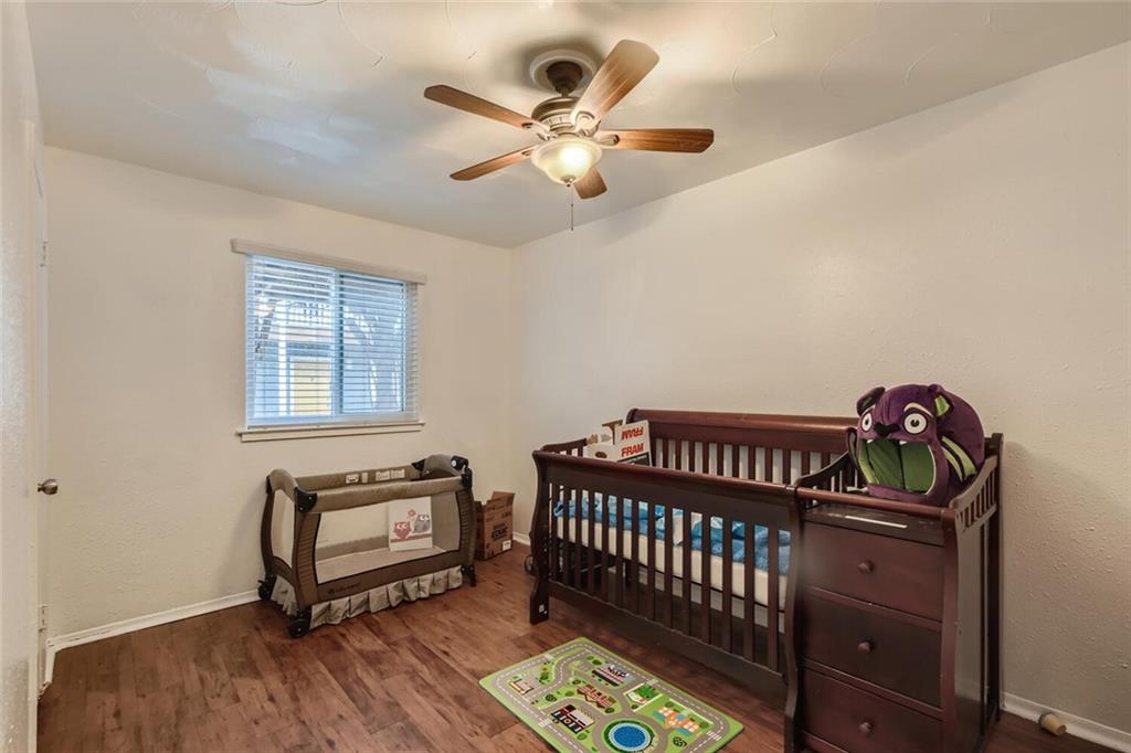 2401 Manor Road, Unit 111 Austin, TX 78722 - Photo 14 of 23 a bedroom with furniture and a window