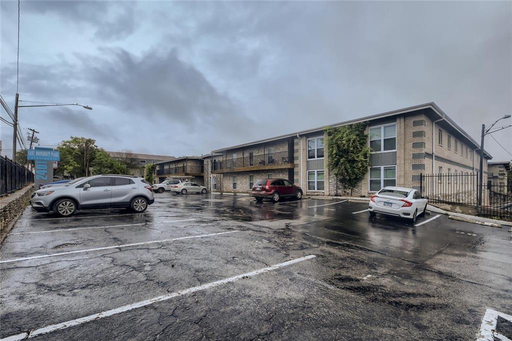 2401 Manor Road, Unit 111 Austin, TX 78722 - Photo 18 of 23 a view of a cars park in front of a building