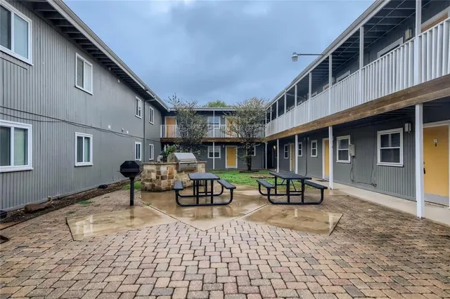 a view of a swimming pool with outdoor seating