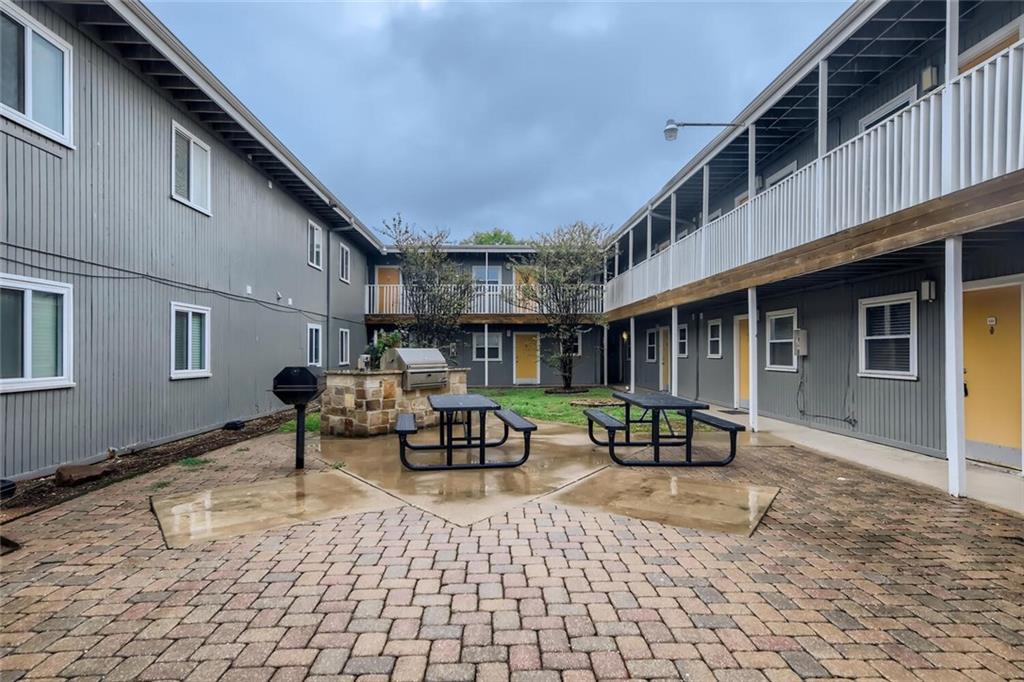 2401 Manor Road, Unit 111 Austin, TX 78722 - Photo 21 of 23 a patio with a table and chairs