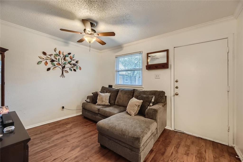 2401 Manor Road, Unit 111 Austin, TX 78722 - Photo 3 of 23 a living room with furniture and a wooden floor