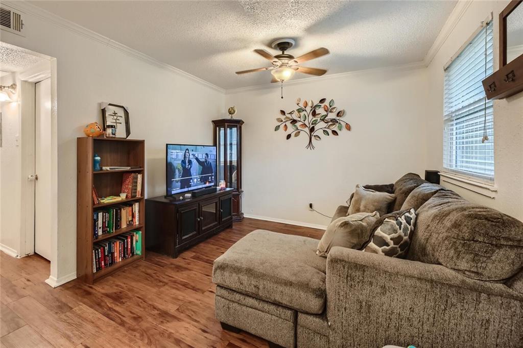 2401 Manor Road, Unit 111 Austin, TX 78722 - Photo 4 of 23 a living room with furniture and a wooden floor