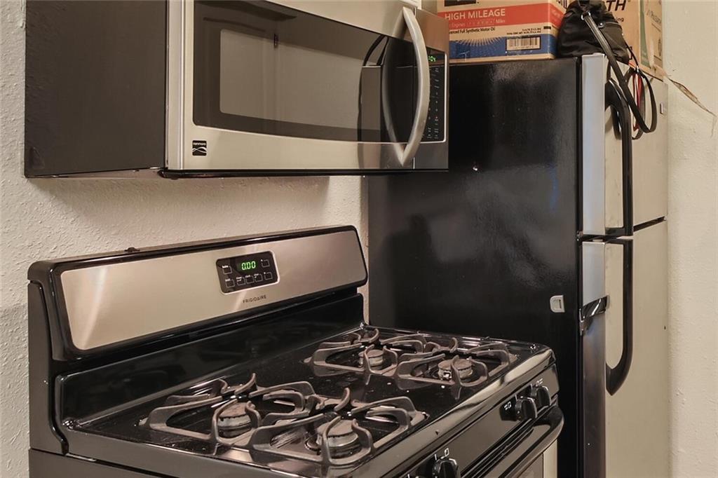 2401 Manor Road, Unit 111 Austin, TX 78722 - Photo 7 of 23 a stove top oven sitting inside of a kitchen