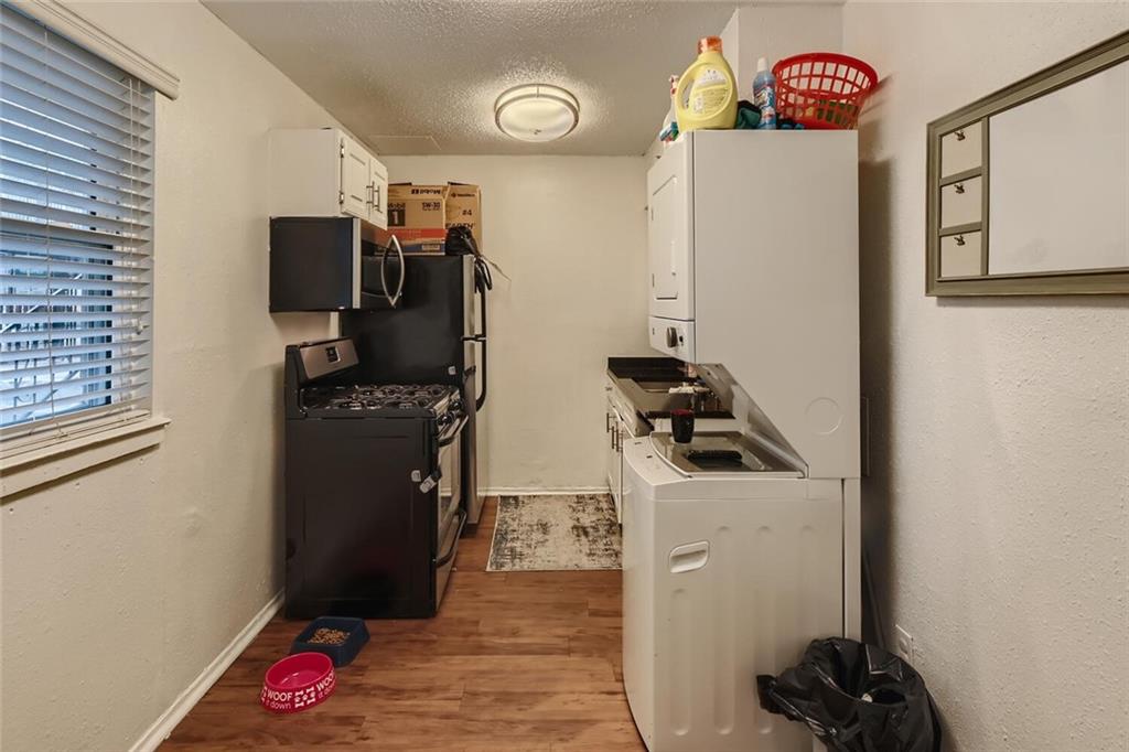 2401 Manor Road, Unit 111 Austin, TX 78722 - Photo 8 of 23 a kitchen with refrigerator and washer