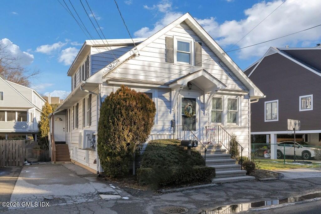 71 Prospect Street, Unit 2 Greenwich, CT 06830 - Photo 2 of 17 a front view of a house with garden