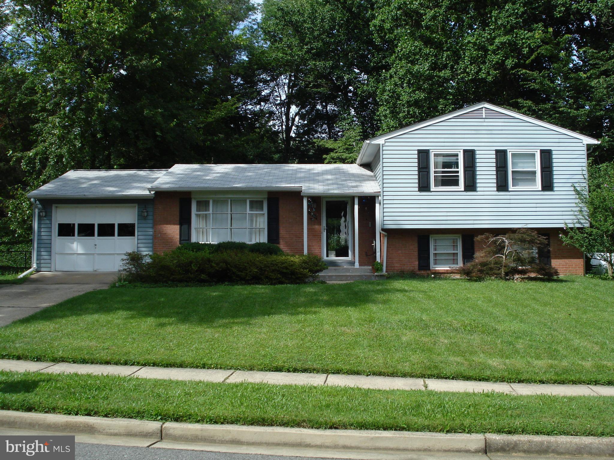 7020 Hadlow Drive Springfield, VA 22152 - Photo 1 of 29 a front view of a house with a garden