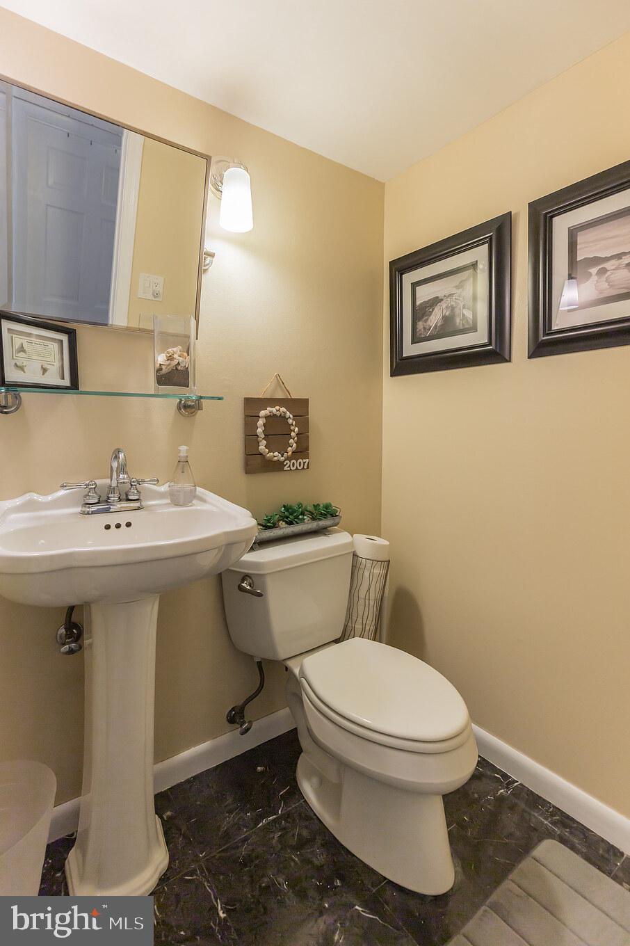 7020 Hadlow Drive Springfield, VA 22152 - Photo 12 of 29 a bathroom with a toilet sink and mirror