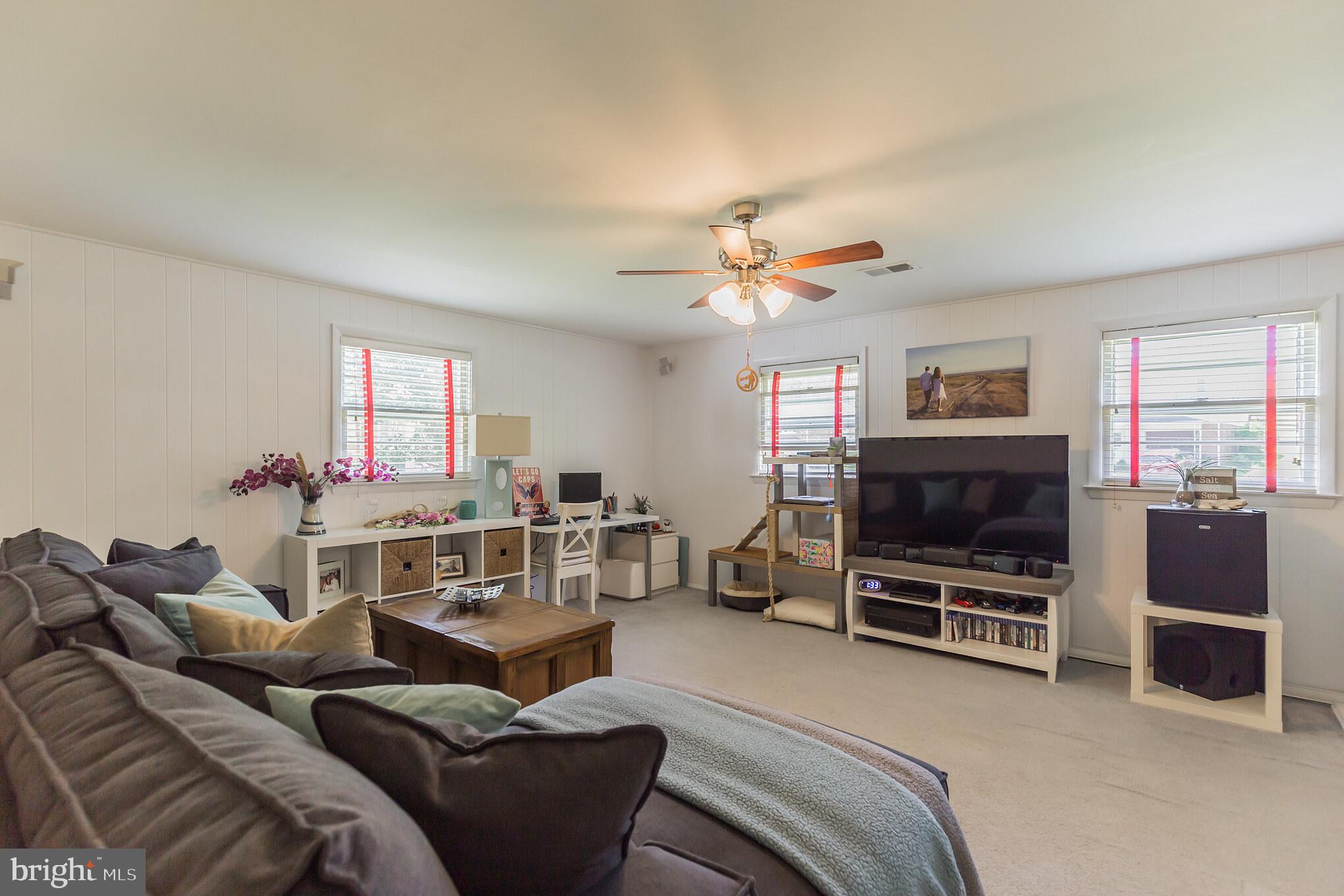 7020 Hadlow Drive Springfield, VA 22152 - Photo 13 of 29 a living room with furniture a flat screen tv and a fireplace