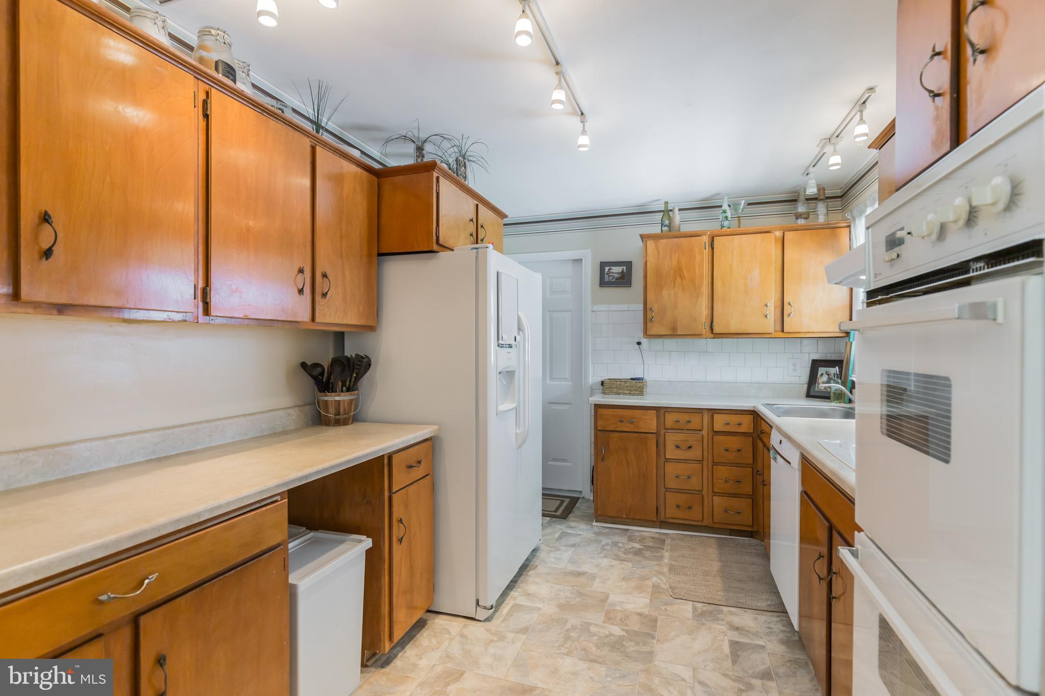 7020 Hadlow Drive Springfield, VA 22152 - Photo 2 of 29 a kitchen with stainless steel appliances a refrigerator sink and stove