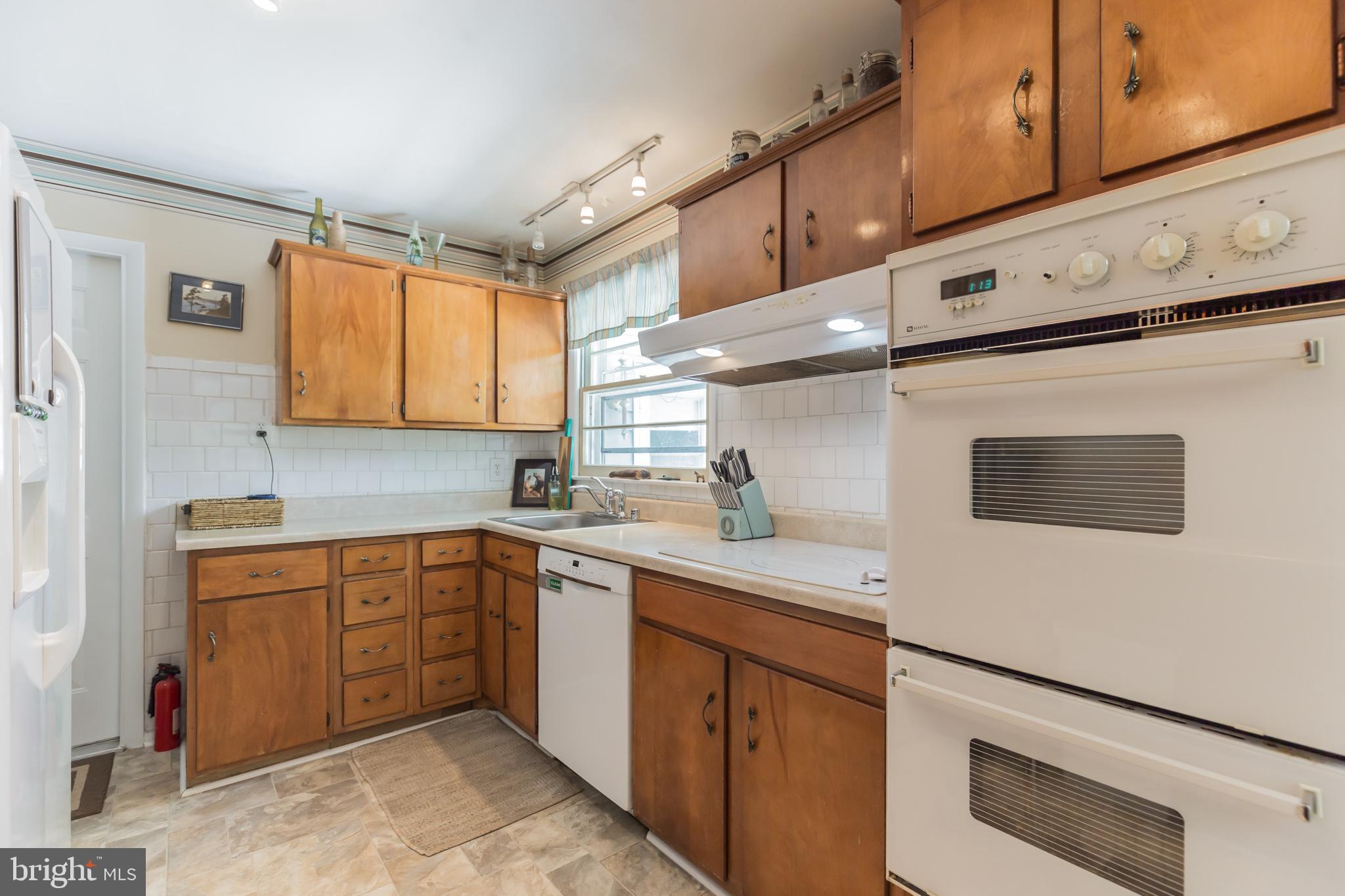 7020 Hadlow Drive Springfield, VA 22152 - Photo 3 of 29 a kitchen with stainless steel appliances granite countertop a sink and cabinets