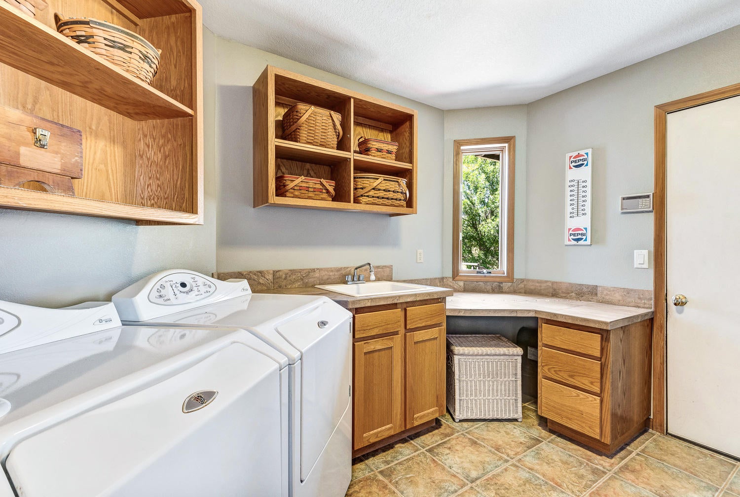 19310 Dayton Road Bend, OR 97703 - Photo 19 of 40 Huge laundry/mud room with ample cabinets and shelves and laundry sink has access to garage.