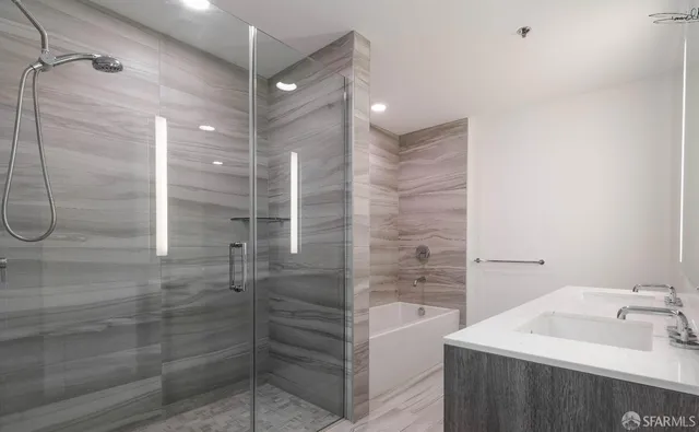 a bathroom with a bathtub and shower