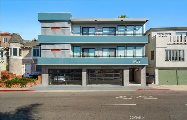 a front view of a building with a yard