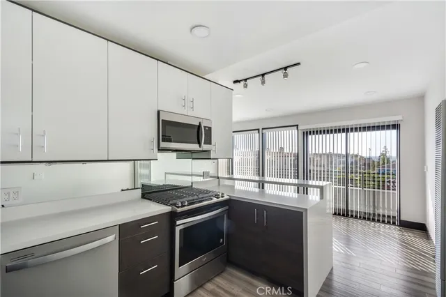 a kitchen with a sink and a stove top oven