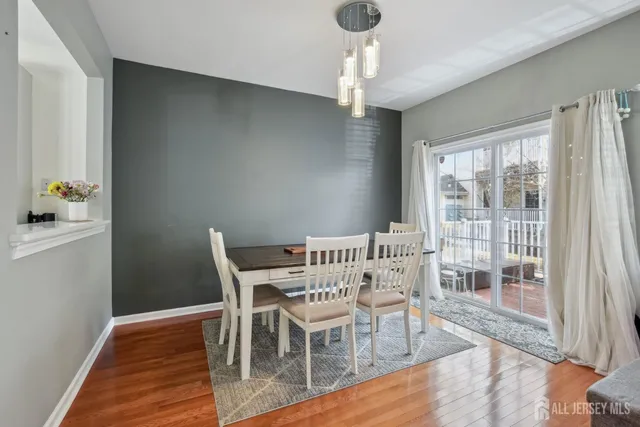 a view of a dining room with furniture wooden floor and chandelier
