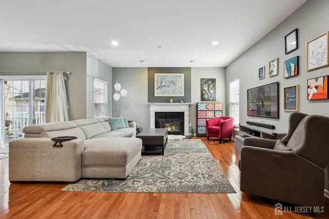 a living room with furniture flat screen tv and a fireplace