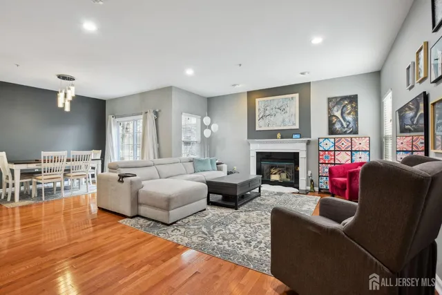 a living room with furniture fireplace and flat screen tv