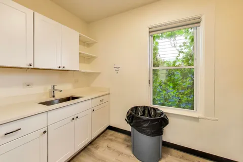 a kitchen with a sink and a stove next to a window