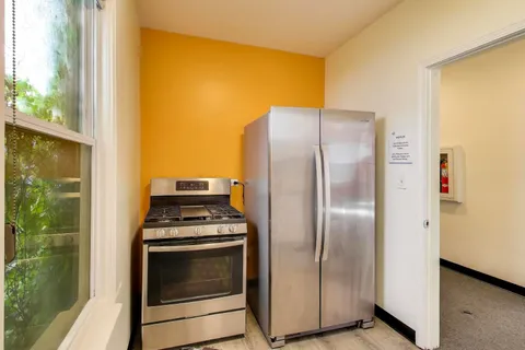 a kitchen with a stove and a refrigerator