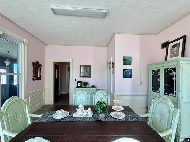 a living room with furniture a clock on wall and a window