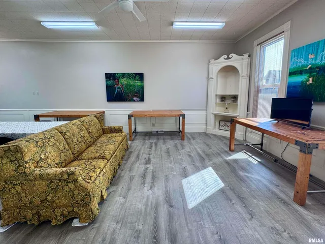 a kitchen with granite countertop a refrigerator a sink dishwasher a stove and white countertops with wooden floor