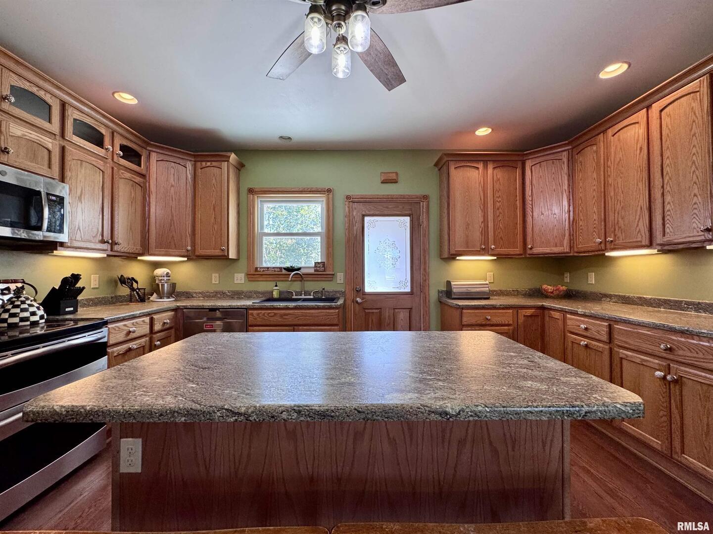 1415 4th Street Fulton, IL 61252 - Photo 34 of 58 a large kitchen with lots of counter space a sink and cabinets
