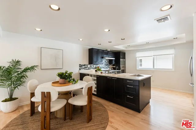 a dining room with furniture and potted plant