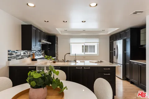 a kitchen with a sink and a stove top oven