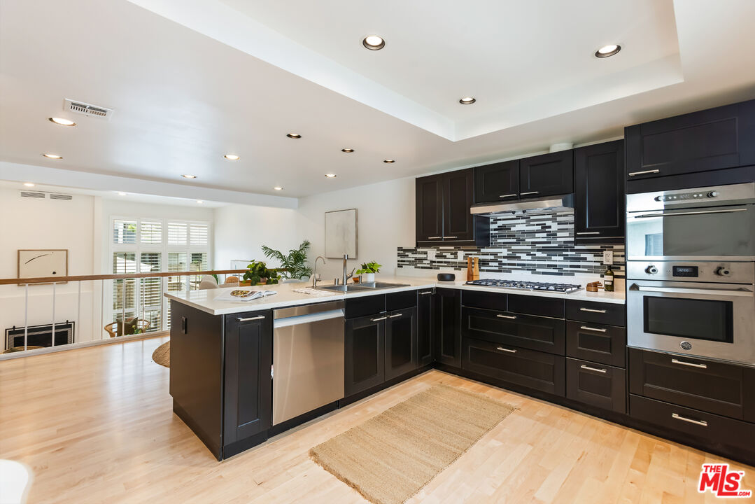 13230 Fiji Way, Unit B Marina del Rey, CA 90292 - Photo 20 of 65 a large kitchen with stainless steel appliances and large cabinets