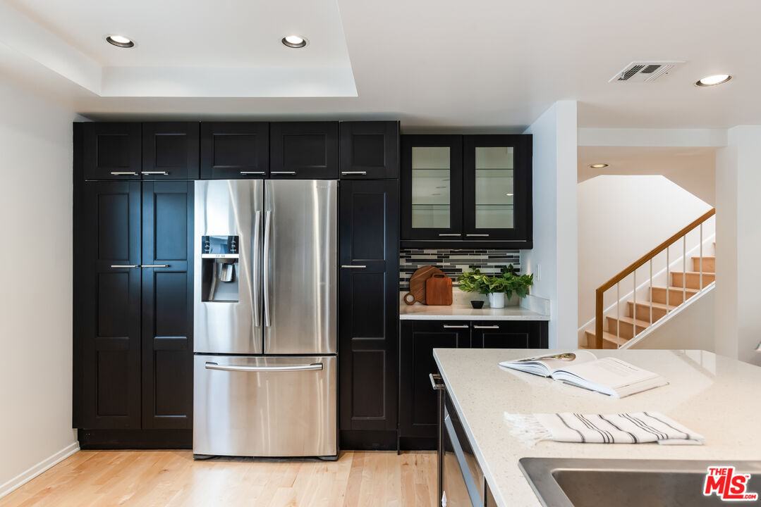 13230 Fiji Way, Unit B Marina del Rey, CA 90292 - Photo 21 of 65 a kitchen with kitchen island a counter top space a sink and refrigerator