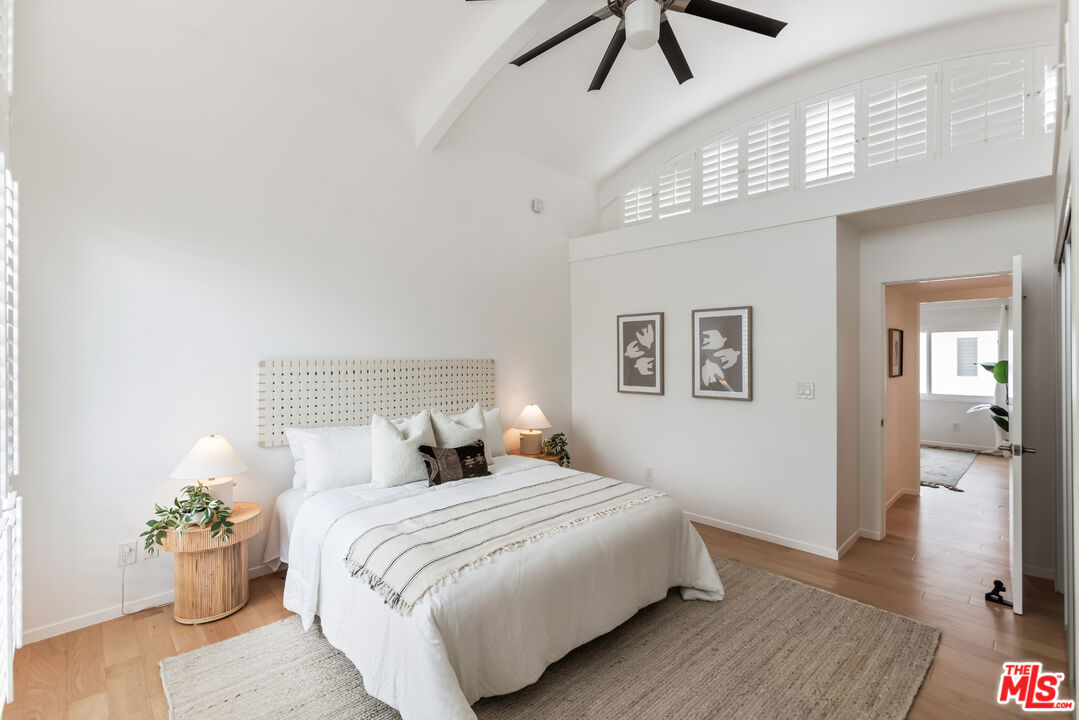 13230 Fiji Way, Unit B Marina del Rey, CA 90292 - Photo 27 of 65 a bedroom with a large bed and a chandelier