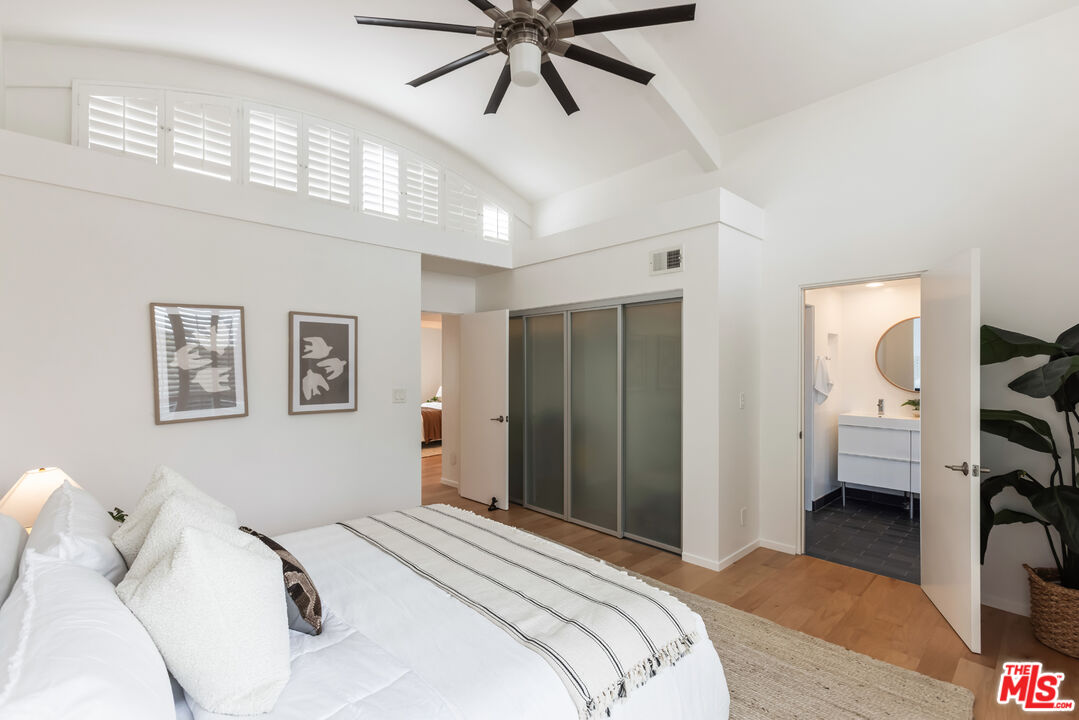 13230 Fiji Way, Unit B Marina del Rey, CA 90292 - Photo 29 of 65 a bedroom with a bed and a chandelier