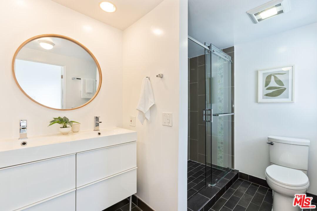 13230 Fiji Way, Unit B Marina del Rey, CA 90292 - Photo 31 of 65 a bathroom with a toilet a sink and mirror