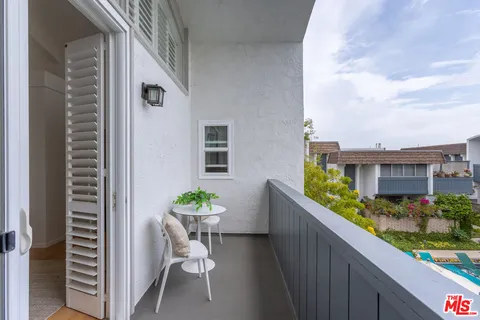a bedroom with a bed and a potted plant