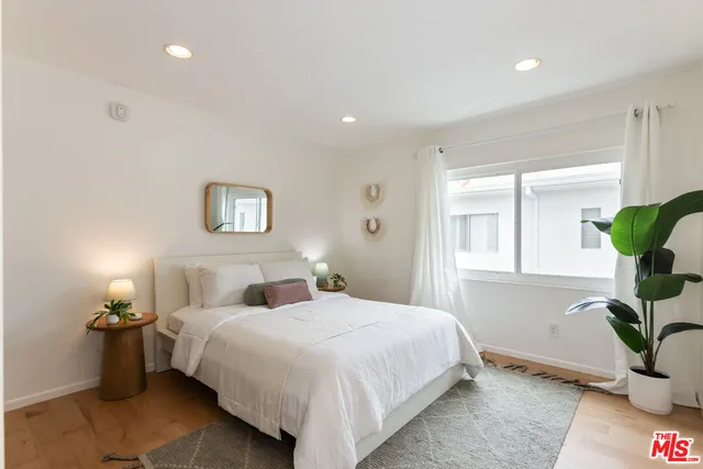 a bedroom with a bed and a painting