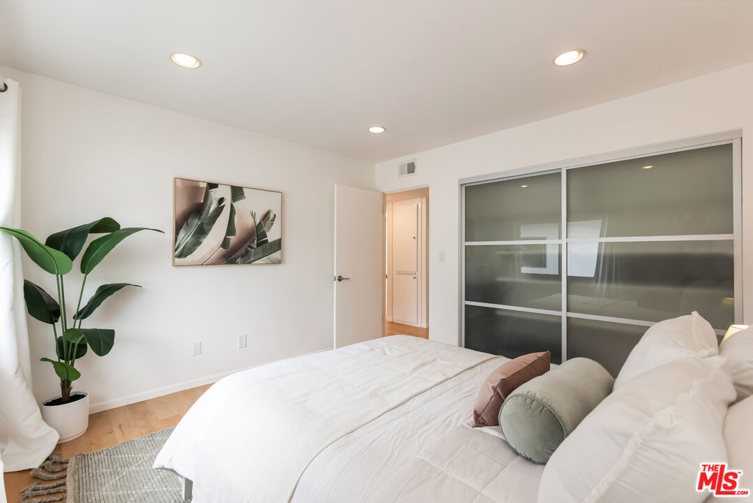 13230 Fiji Way, Unit B Marina del Rey, CA 90292 - Photo 44 of 65 a bedroom with a bed and a potted plant