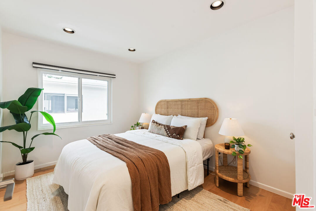 13230 Fiji Way, Unit B Marina del Rey, CA 90292 - Photo 46 of 65 a bedroom with a bed table flowerpot and window
