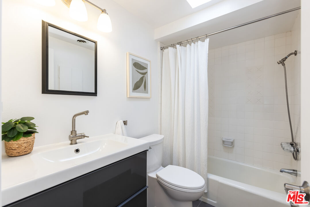 13230 Fiji Way, Unit B Marina del Rey, CA 90292 - Photo 51 of 65 a bathroom with a sink a toilet and shower