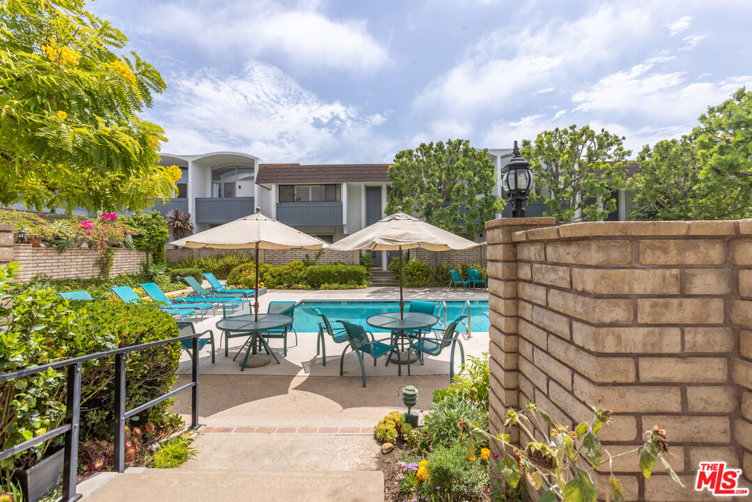 13230 Fiji Way, Unit B Marina del Rey, CA 90292 - Photo 60 of 65 a view of a patio with chairs and table under an umbrella