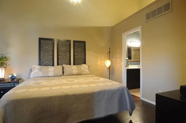 a bedroom with a bed and a potted plant