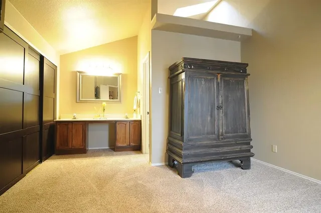 a bathroom with a tub shower and mirror